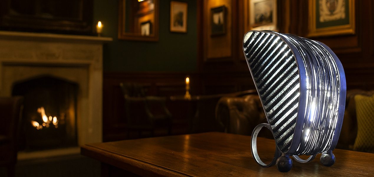 Lampe Sype 014 Dualité Métallique, création lumineuse artisanale en acier brut et fils recuits, ambiance feutrée et élégante.