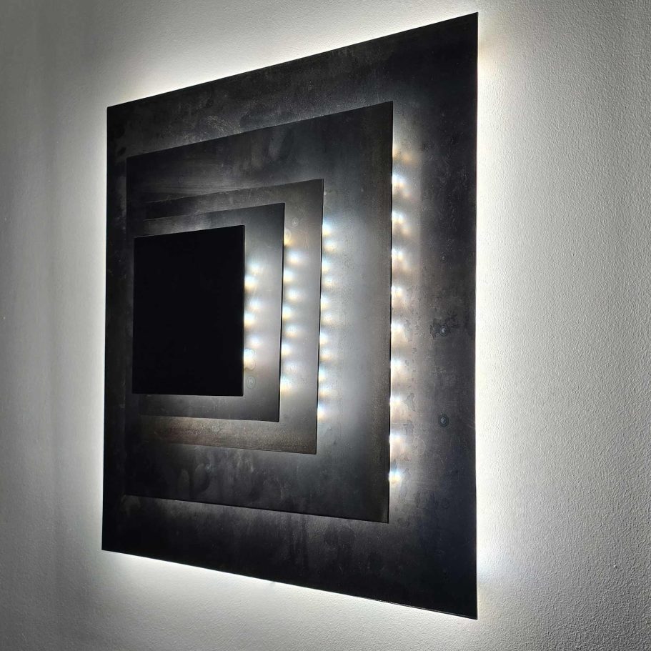 Détail lumineux de la sculpture Sype 010 Pyramide de Carrés, reflets sur acier poli et dégradés d’ombre.