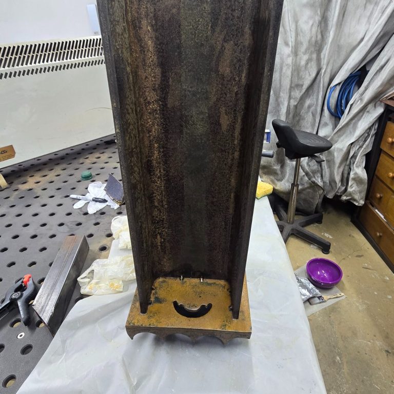 Détail d’une sculpture lumineuse Sype Design où la lumière glisse sur l’acier poli — reflets dorés et jeu d’ombres poétiques.