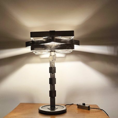 Sype 003 - Carrés en équilibre – Lampe sculpture géométrique en acier Lampe verticale en acier brut composée de carrés pleins et évidés empilés en équilibre.